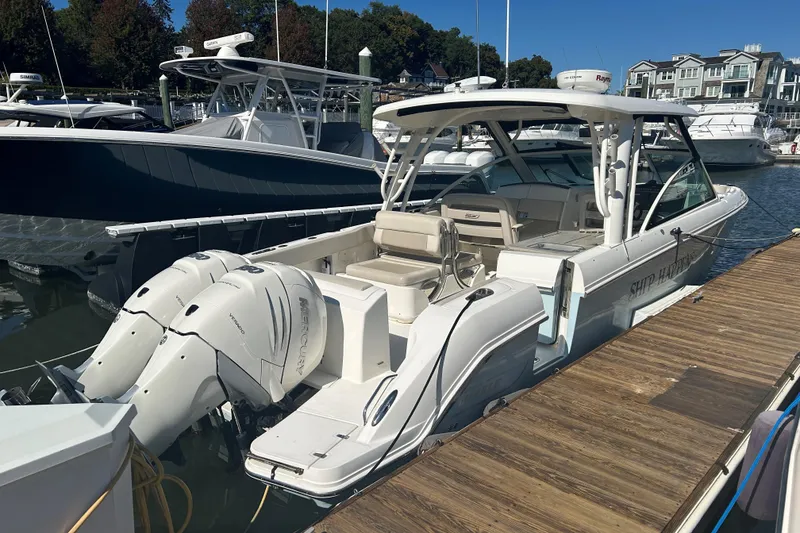 Slide: The Image of 2018 Boston Whaler 320 Vantage docked, featuring dual Mercury outboard engines. - 4