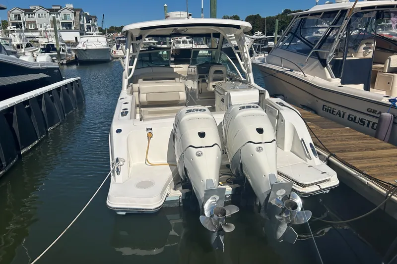 Slide: The Image of 2018 Boston Whaler 320 Vantage docked at marina with twin engines. - 6