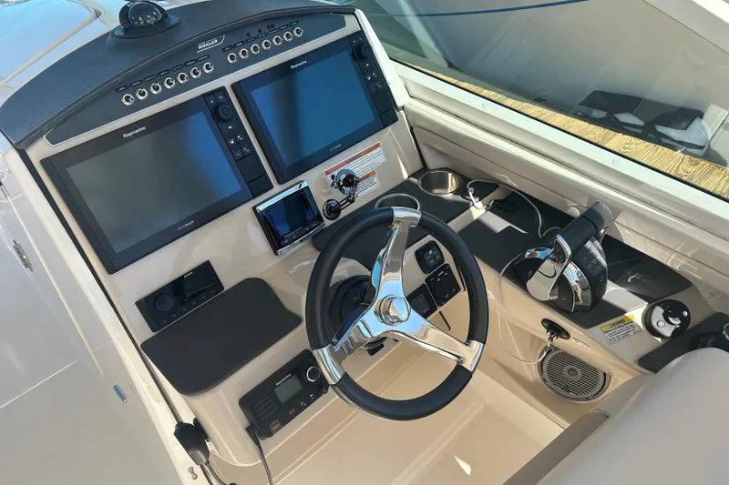 Slide: The Image of 2018 Boston Whaler 320 Vantage helm with dual screens and modern controls. - 8