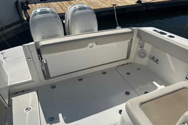 Slide: The Image of 2018 Boston Whaler 320 Vantage boat interior with dual engines and seating area. - 9