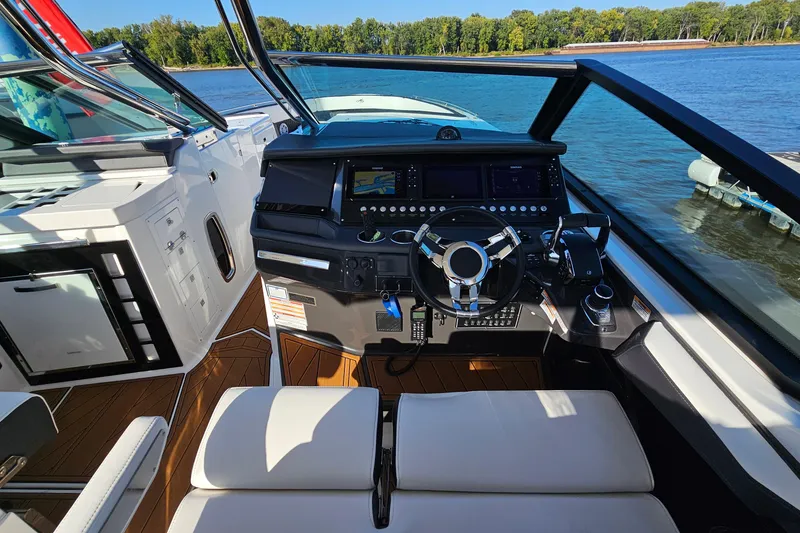 Slide: The Image of Cockpit of 2022 Monterey 378SS Super Sport boat with modern controls and scenic water view. - 15