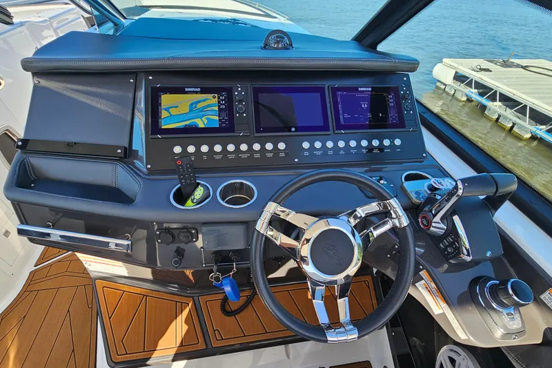 Slide: The Image of 2022 Monterey 378SS Super Sport boat dashboard with navigation screens and steering wheel. - 16