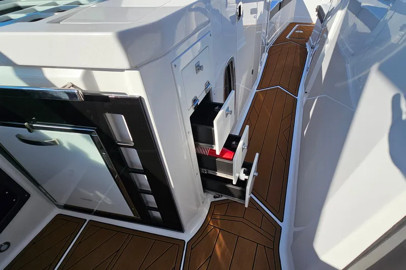 Slide: The Image of 2022 Monterey 378SS Super Sport boat interior with sleek wood flooring and storage compartments. - 19