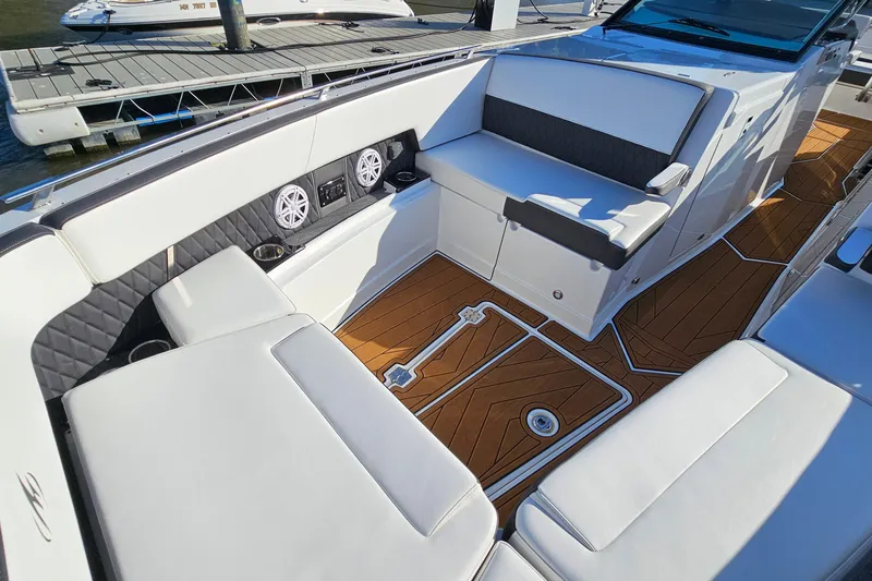 Slide: The Image of 2022 Monterey 378SS Super Sport boat interior with white seating and wood-style flooring. - 22