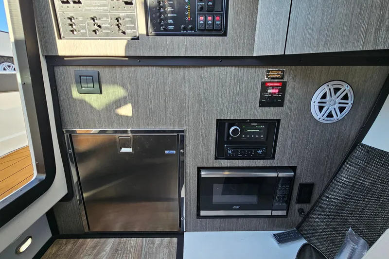 Slide: The Image of 2022 Monterey 378SS Super Sport interior with control panel, microwave, and speaker. - 27