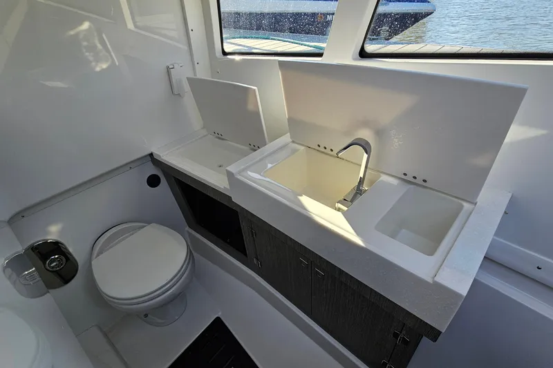 Slide: The Image of 2022 Monterey 378SS Super Sport boat bathroom with sink and toilet, featuring modern design. - 29