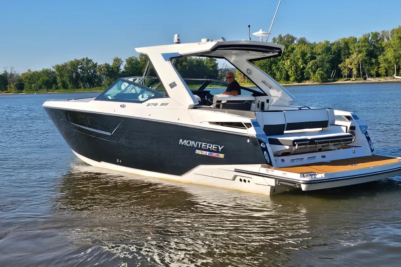 Slide: The Image of 2022 Monterey 378SS Super Sport boat cruising on a calm river with lush green trees. - 3