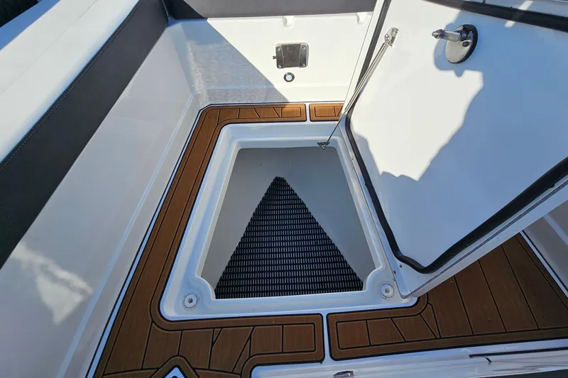 Slide: The Image of 2022 Monterey 378SS Super Sport boat storage compartment with open hatch and wood-like flooring. - 31