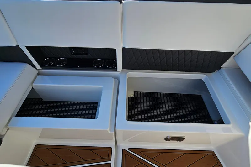 Slide: The Image of 2022 Monterey 378SS Super Sport boat interior with storage compartments and cup holders. - 32