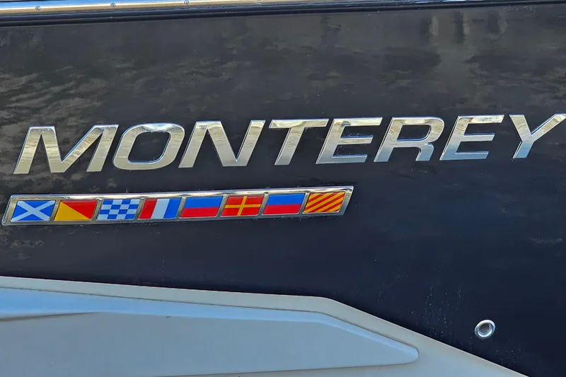 Slide: The Image of 2022 Monterey 378SS Super Sport boat logo with nautical flags on dark background. - 39