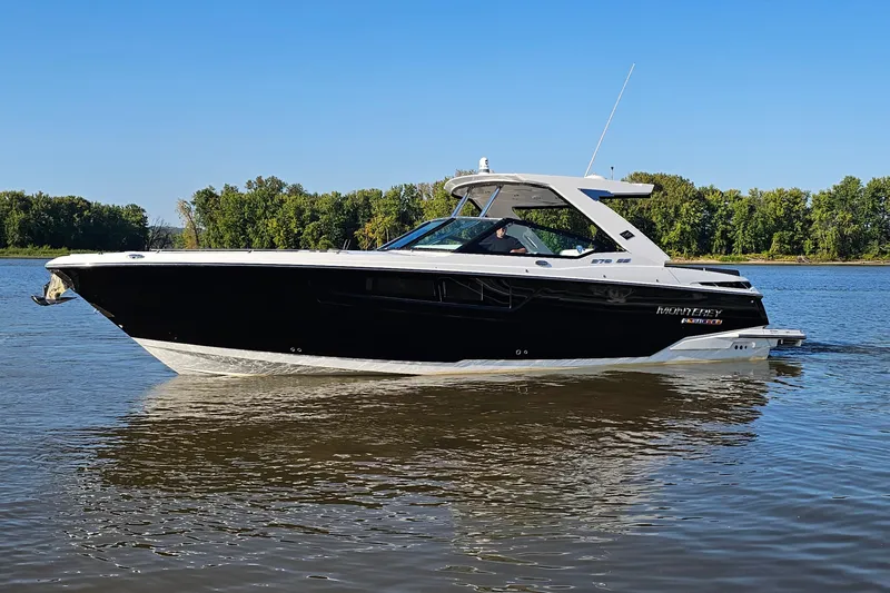 Slide: The Image of 2022 Monterey 378SS Super Sport boat cruising on a calm river with forested background. - 4