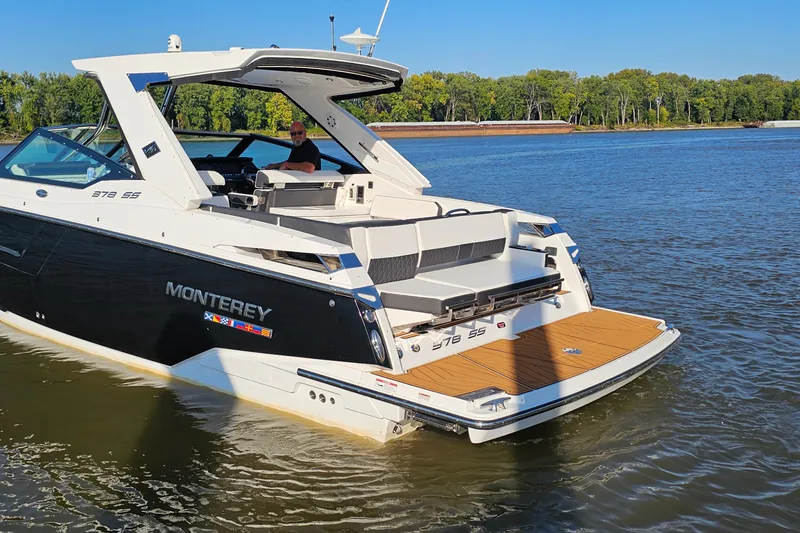 Slide: The Image of 2022 Monterey 378SS Super Sport boat on calm water, featuring sleek design and spacious deck. - 5