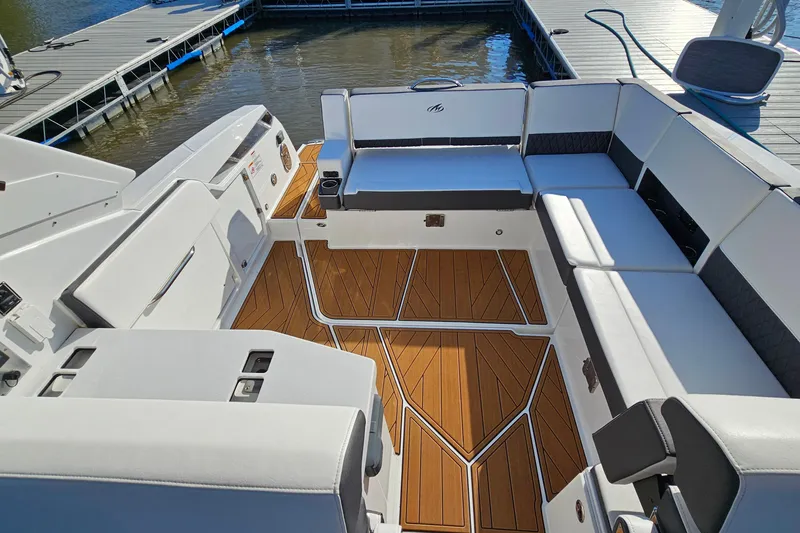 Slide: The Image of 2022 Monterey 378SS Super Sport boat interior with white seating and wooden flooring. - 7