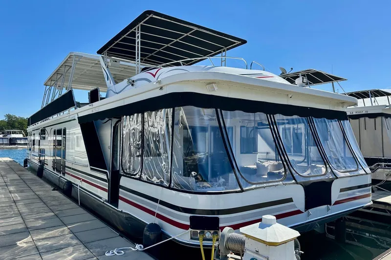 The Image of 2003 Sumerset 18x80 houseboat docked, featuring spacious upper deck and modern design. - 0