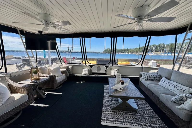 Slide: The Image of Luxurious 2003 Sumerset 18x80 houseboat interior with lake view, featuring cozy seating and modern decor. - 1