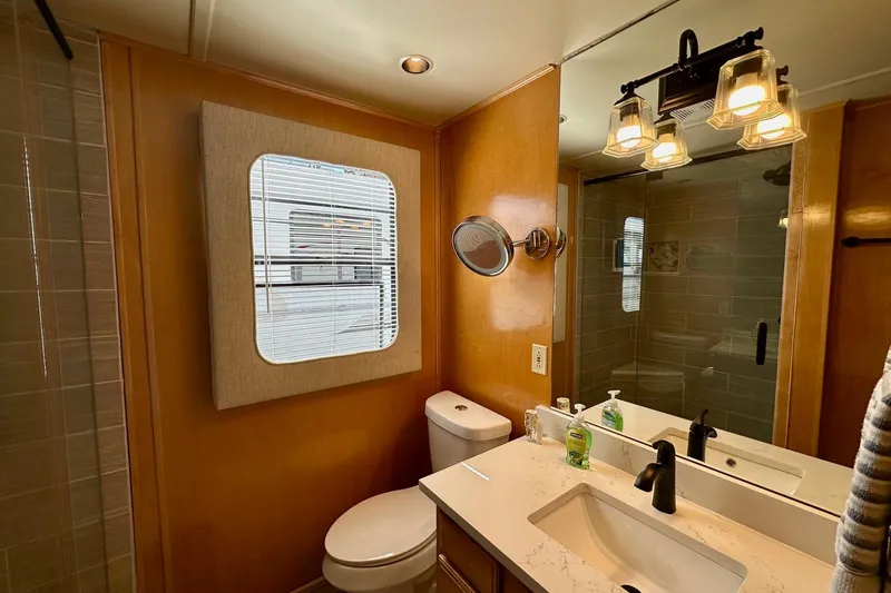 Slide: The Image of Bathroom interior of 2003 Sumerset 18x80 houseboat with modern fixtures and wooden accents. - 10