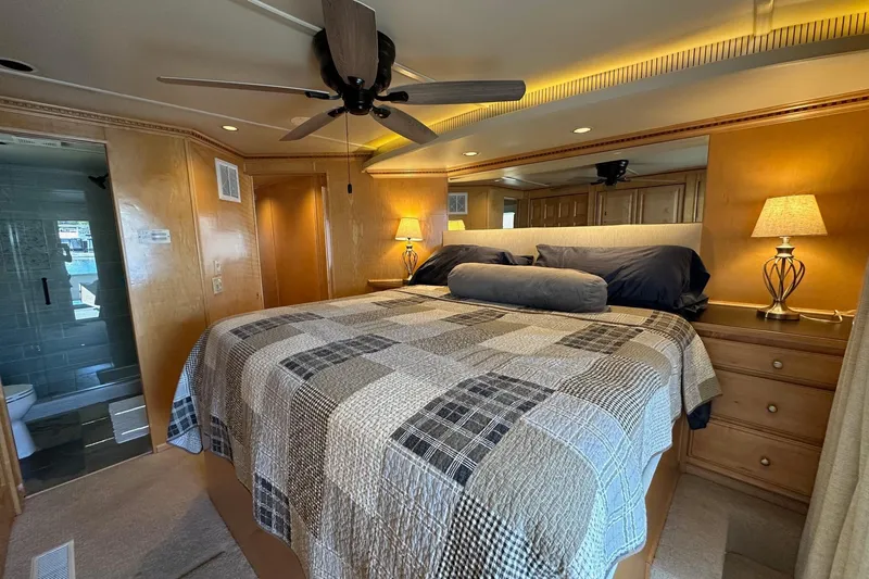 Slide: The Image of Luxurious bedroom in 2003 Sumerset 18x80 houseboat with cozy bedding and elegant lighting. - 11