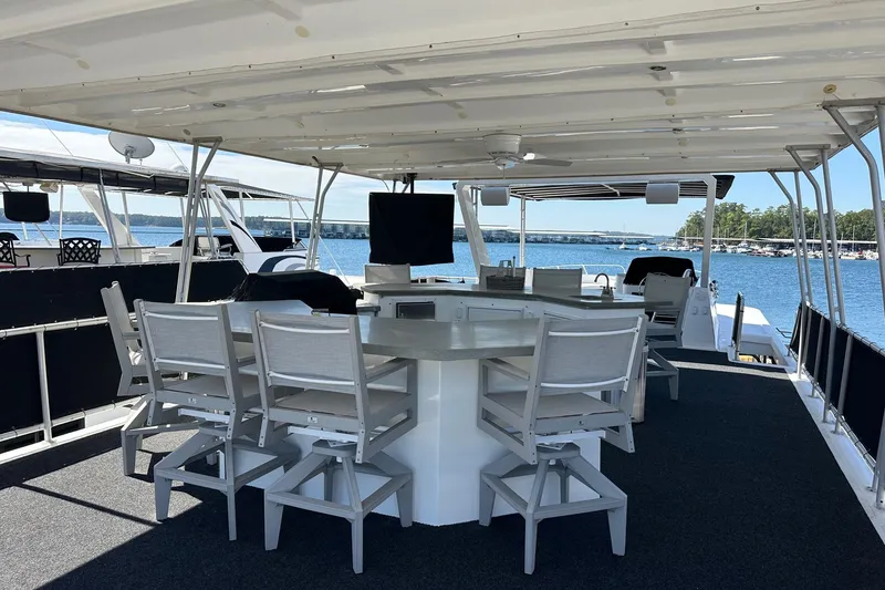 Slide: The Image of Outdoor seating area on a 2003 Sumerset 18x80 houseboat with lake view. - 14