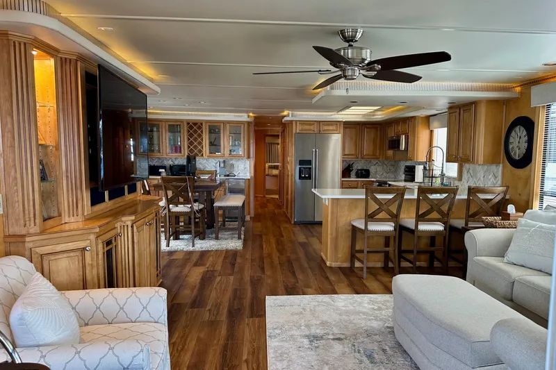 Slide: The Image of Luxurious 2003 Sumerset 18x80 houseboat interior with modern kitchen, wooden cabinetry, and cozy seating area. - 2
