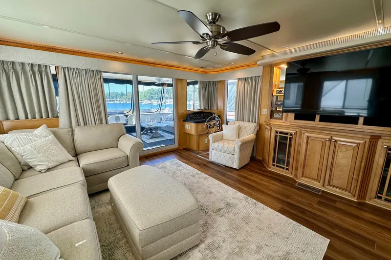 Slide: The Image of Luxurious 2003 Sumerset 18x80 houseboat interior with cozy seating, large TV, and elegant decor. - 3