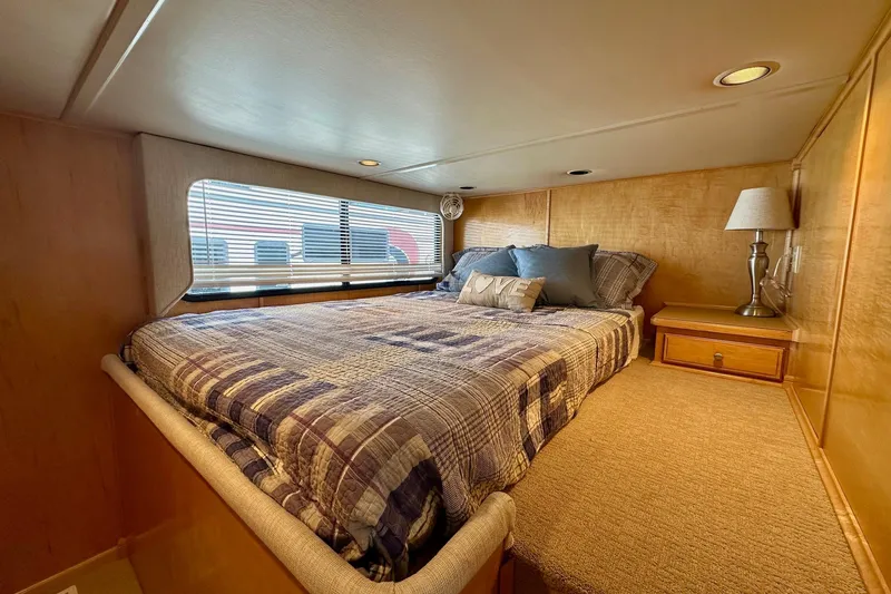Slide: The Image of Cozy bedroom in 2003 Sumerset 18x80 houseboat with plaid bedding and decorative pillows. - 7