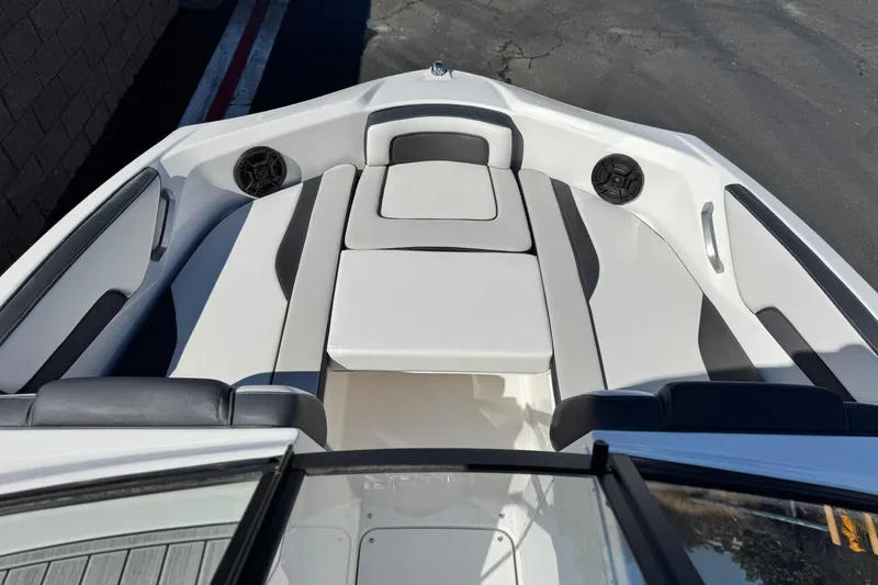 Slide: The Image of 2023 Yamaha Boats AR195 interior with sleek seating and built-in speakers. - 12