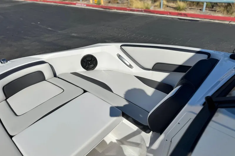 Slide: The Image of 2023 Yamaha Boats AR195 interior with sleek white and black seating design. - 14
