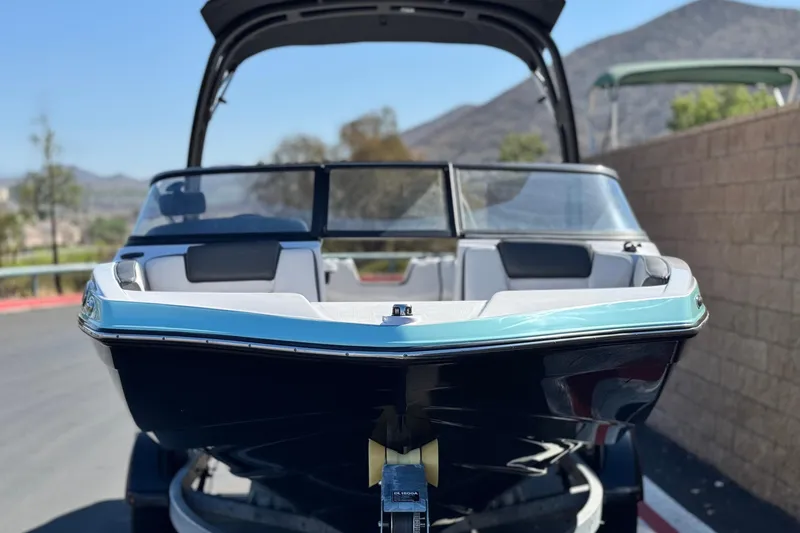 Slide: The Image of 2023 Yamaha Boats AR195 on trailer, sleek design, mountain backdrop. - 2