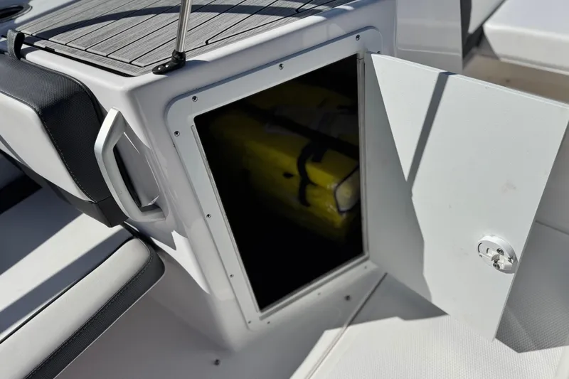 Slide: The Image of Open storage compartment on 2023 Yamaha AR195 boat, revealing interior space. - 20
