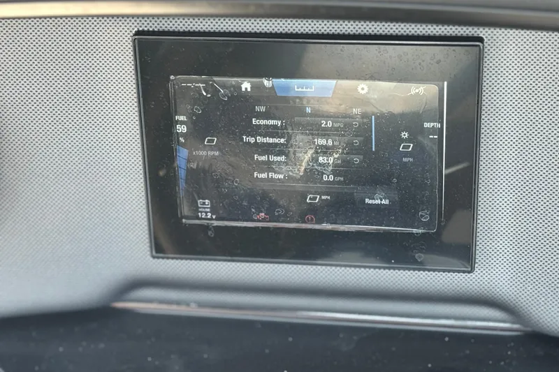Slide: The Image of Dashboard display of 2023 Yamaha Boats AR195 showing fuel and trip data. - 26