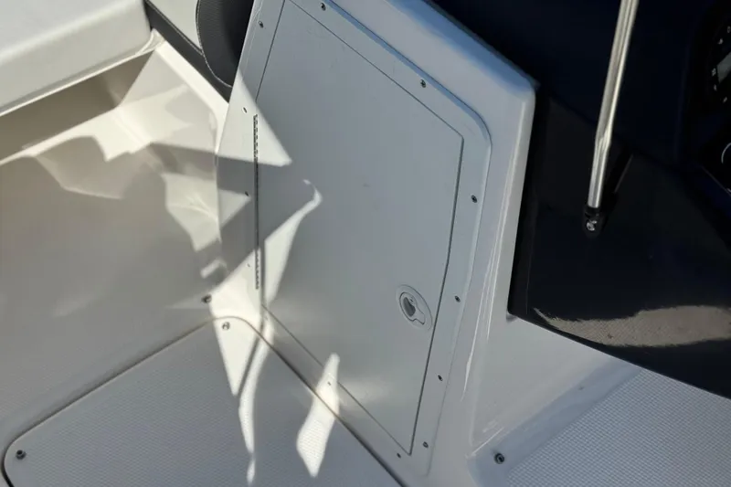 Slide: The Image of 2023 Yamaha Boats AR195 interior storage compartment with sleek design and secure latch. - 27