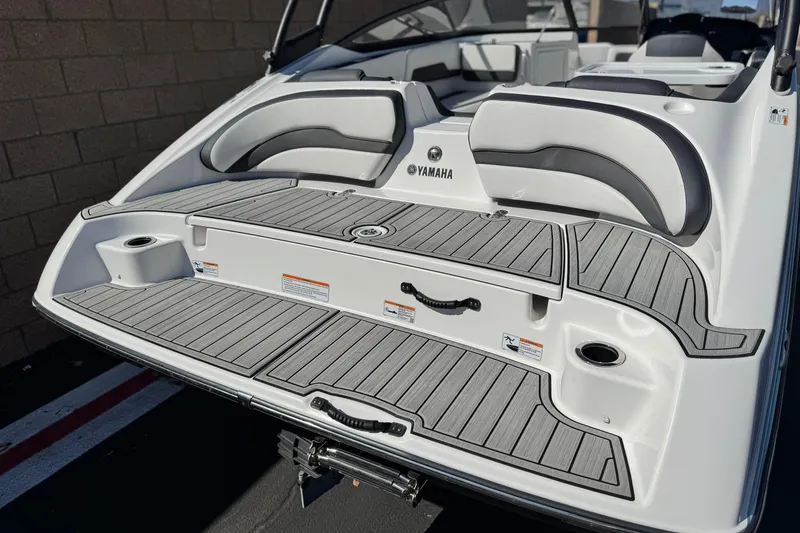 Slide: The Image of 2023 Yamaha Boats AR195 swim platform with cushioned seating and sleek design. - 6