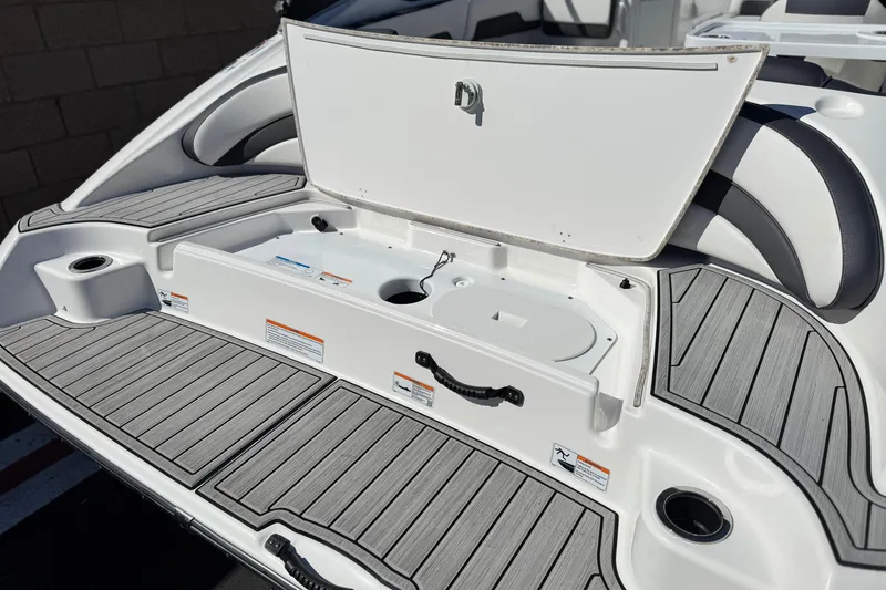 Slide: The Image of 2023 Yamaha AR195 boat with open storage compartment and sleek deck design. - 7