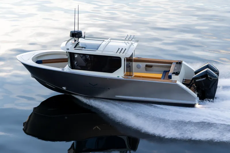 Slide: The Image of 2026 Jasper Marine Defender 22 boat on serene lake with mountainous backdrop at dusk. - 16