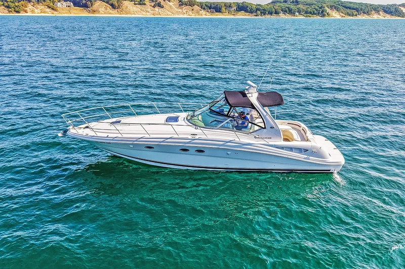 The Image of 2003 Sea Ray 420 Sundancer yacht cruising on clear blue water. - 0