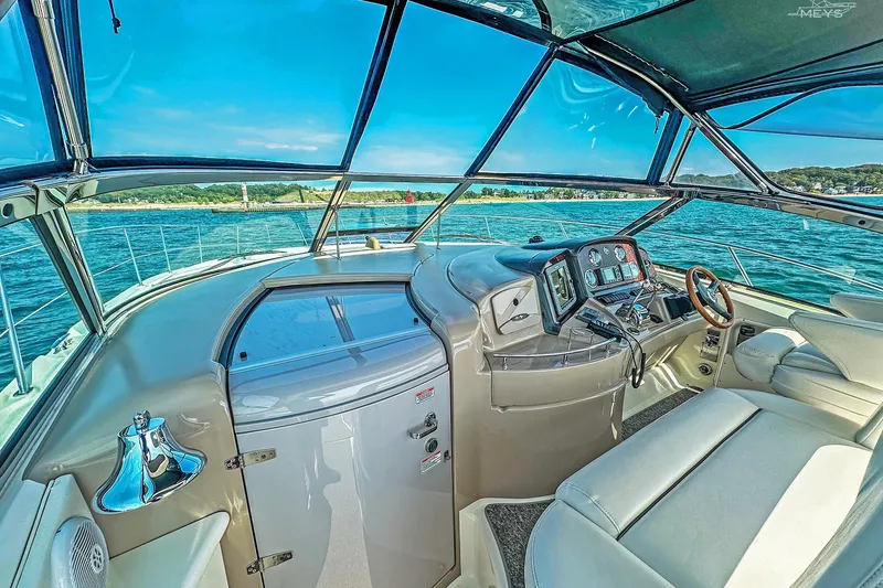 Slide: The Image of 2003 Sea Ray 420 Sundancer yacht cockpit with modern controls and scenic ocean view. - 10