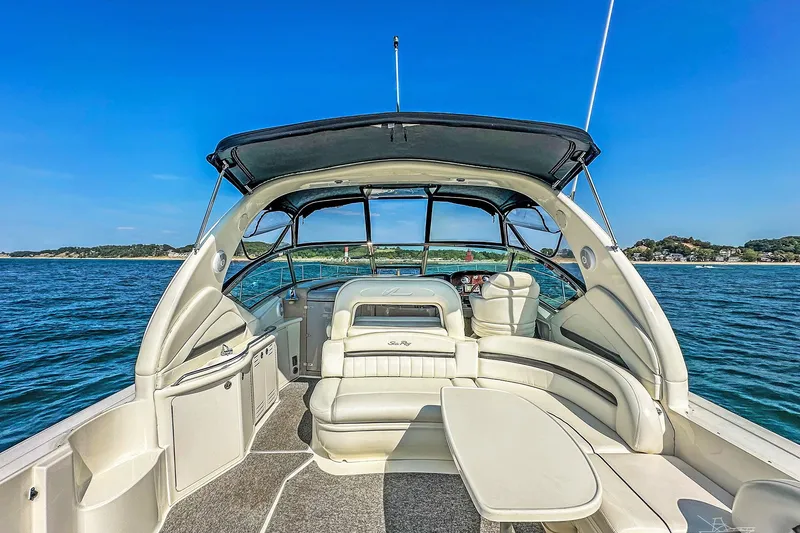 Slide: The Image of 2003 Sea Ray 420 Sundancer yacht interior with seating, table, and ocean view. - 13