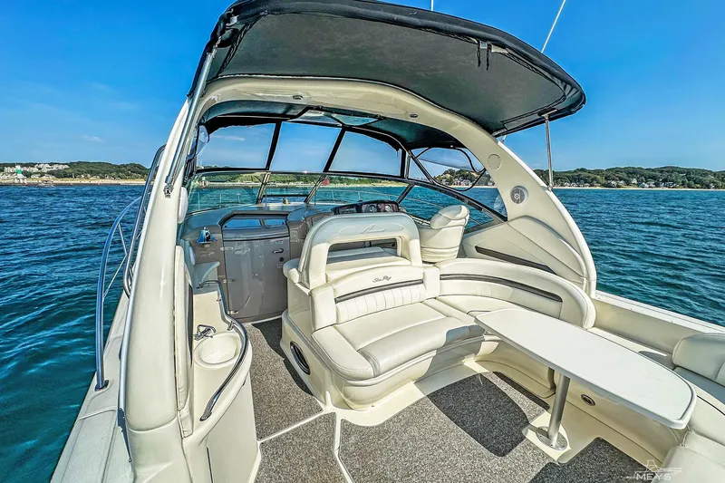 Slide: The Image of 2003 Sea Ray 420 Sundancer yacht interior with seating and table on open water. - 14