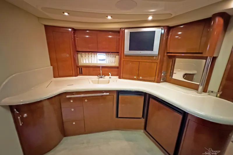 Slide: The Image of Luxurious 2003 Sea Ray 420 Sundancer yacht interior with elegant wood cabinetry and modern amenities. - 18