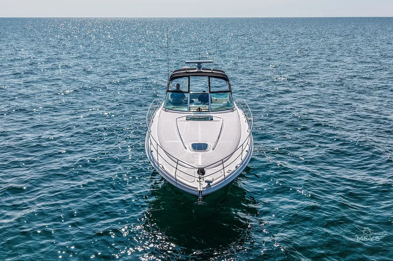 Slide: The Image of 2003 Sea Ray 420 Sundancer yacht cruising on open water under clear skies. - 2