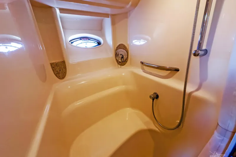 Slide: The Image of Shower area in 2003 Sea Ray 420 Sundancer yacht with porthole and handrail. - 27