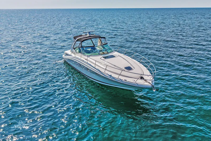 Slide: The Image of 2003 Sea Ray 420 Sundancer yacht cruising on clear blue ocean waters. - 3