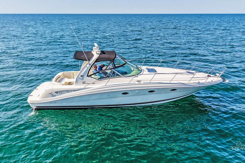 Slide: The Image of 2003 Sea Ray 420 Sundancer yacht cruising on open blue water. - 4