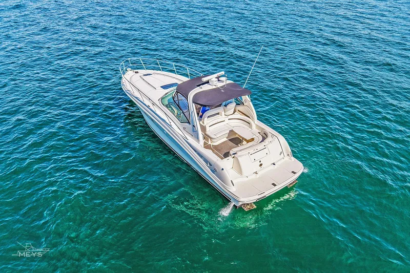 Slide: The Image of 2003 Sea Ray 420 Sundancer yacht cruising on clear blue water. - 7