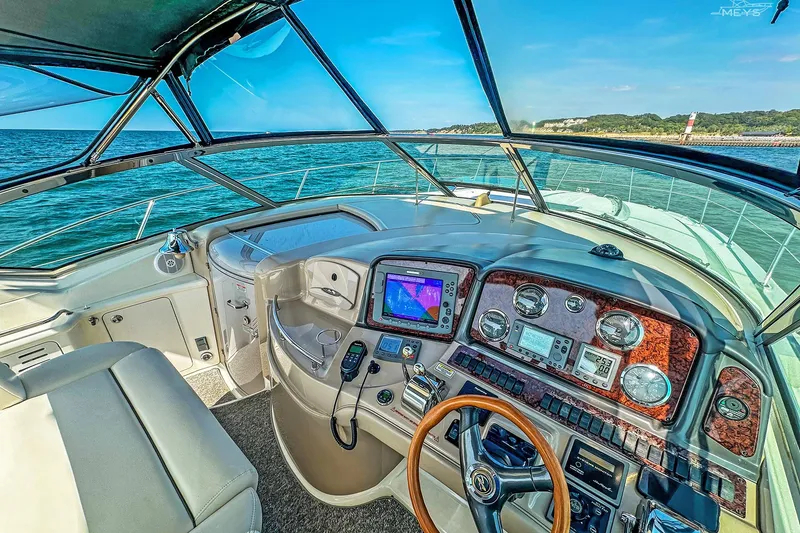 Slide: The Image of 2003 Sea Ray 420 Sundancer helm with navigation equipment and ocean view. - 9