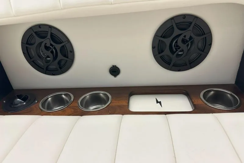 Slide: The Image of Interior of 2025 StanCraft 260 Day Boat with speakers, cup holders, and charging port. - 13