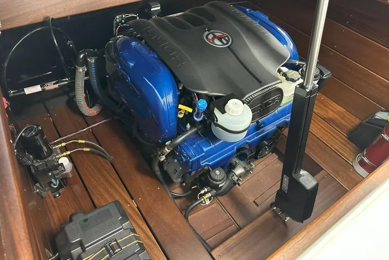 Slide: The Image of Engine compartment of 2025 StanCraft 260 Day Boat with blue and black components. - 17