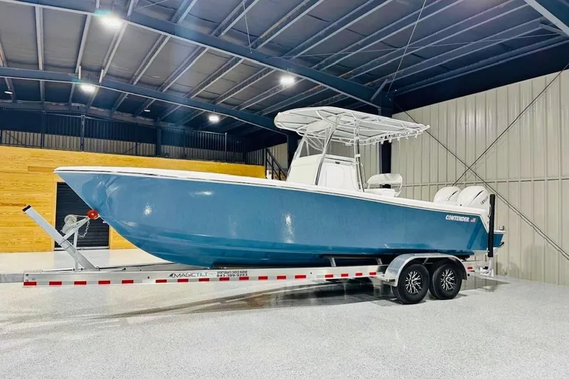 Slide: The Image of 2025 Contender 28 Tournament boat on trailer in indoor storage facility. - 1