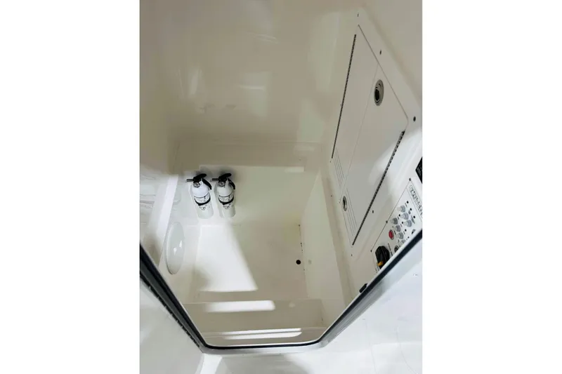 Slide: The Image of Interior of 2025 Contender 28 Tournament boat with fire extinguishers and control panel. - 13