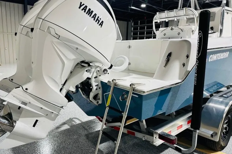 Slide: The Image of 2025 Contender 28 Tournament boat with Yamaha engines on a trailer in a showroom. - 14